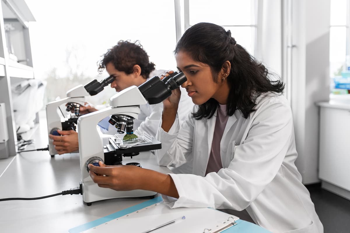 Scientists looking through microscopes
