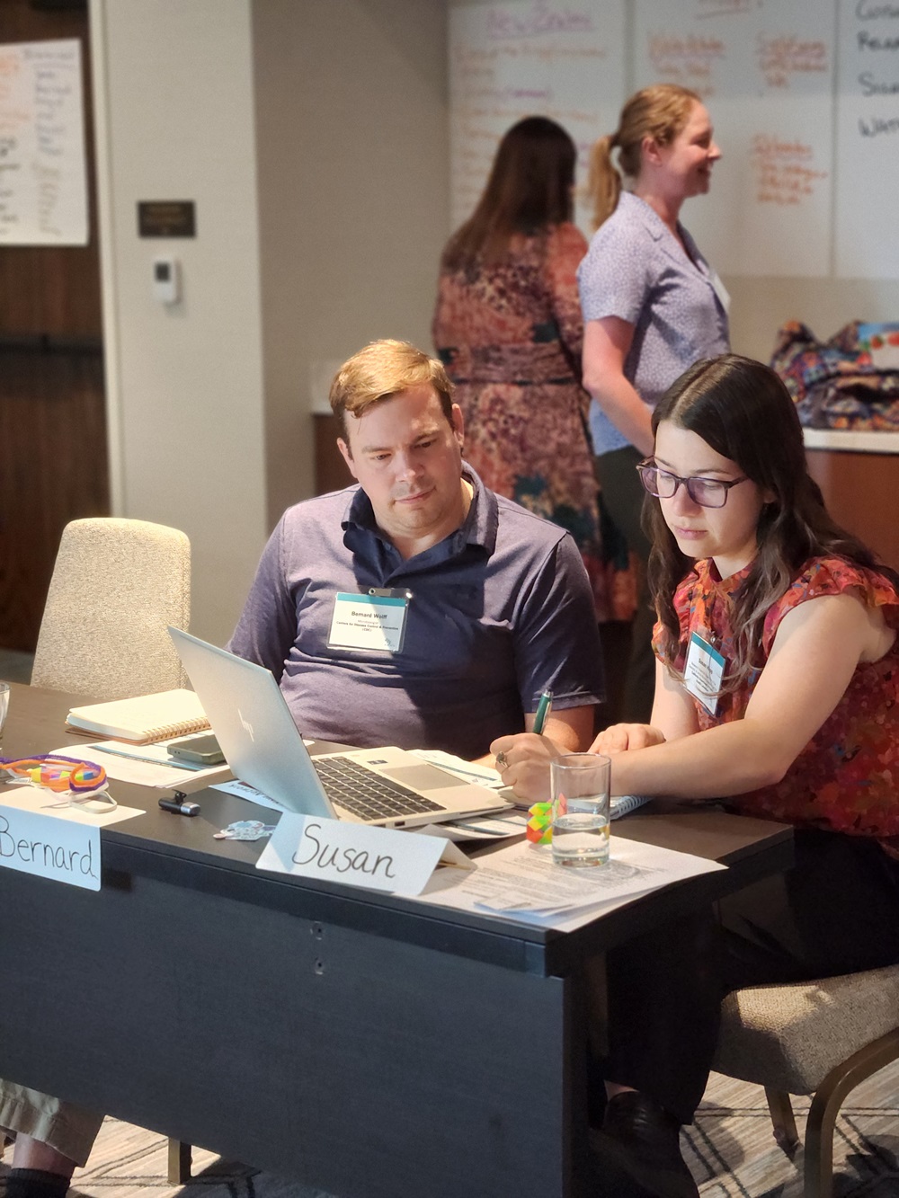 : ELP Cohort 19 (Hybrid Modality) members work together preparing to lead an effective meeting example for their cohort.