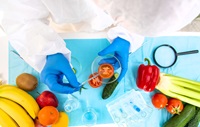 scientist examining a tomato in a petri dish in a lab