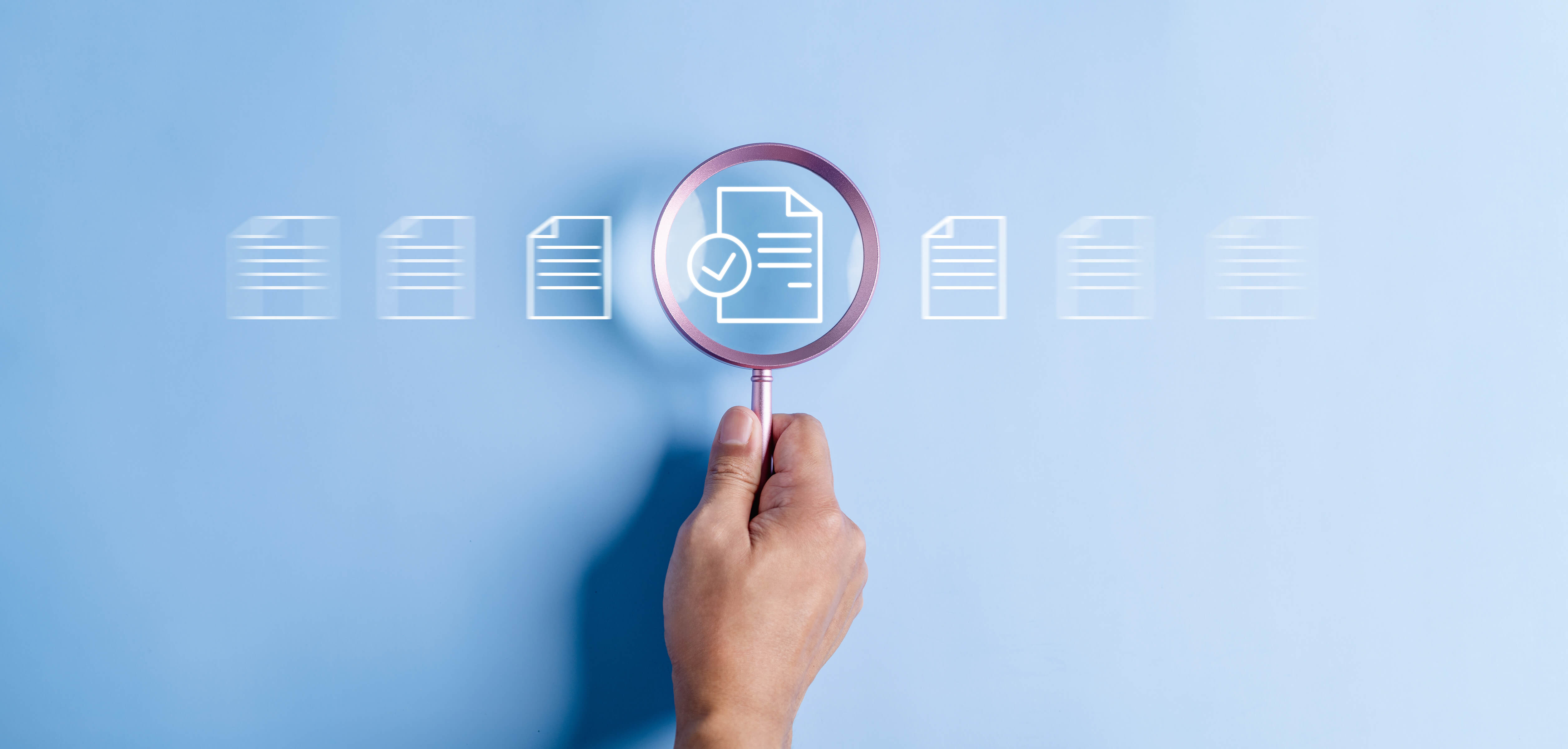 magnifying glass over document with check mark