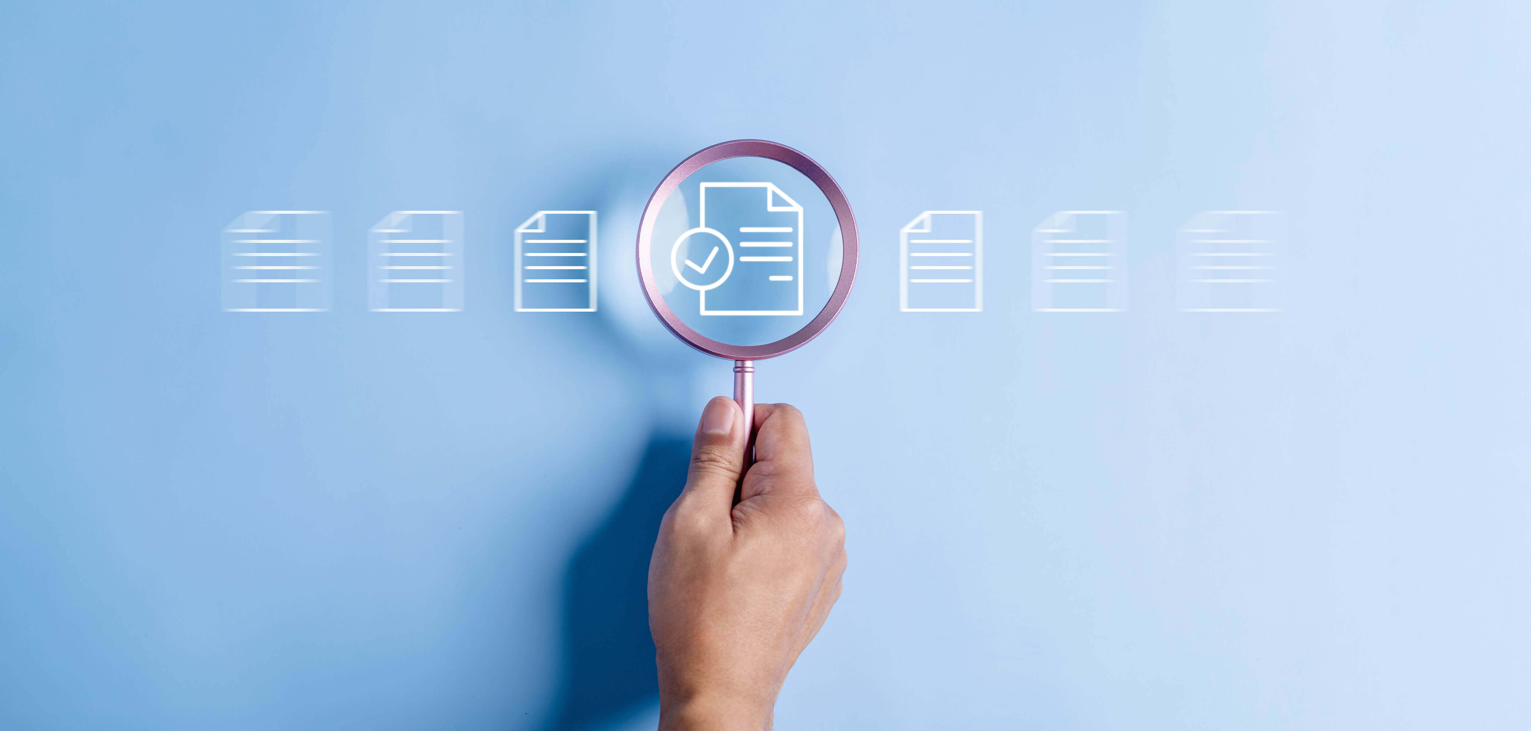 magnifying glass over document with check mark